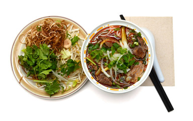 Bun Ho Hue or Vietnamese vermicelli noodles with beef on a white background © annguyen