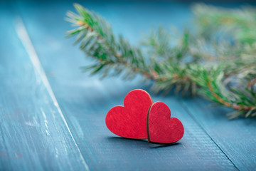 Two red wooden hearts on blue table. Christmas decoration. Copy space. Valentine. Love.