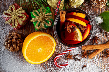 Hot Mulled wine with cinnamon sticks, orange, lime. christmas concept.