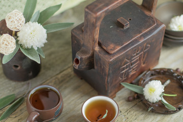 Tea break time. Small ceramic chinese cups with hot tea and squa