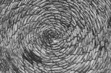 Dirty rustic handmade straw, rope round carpet rug closeup black and white horizontal background