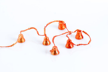 Christmas decoration with red bells on rope isolated on white