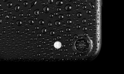 Black matte smartphone with waterdrops, isolated on white backgr