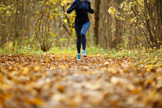 Girl in sportswear running autumn