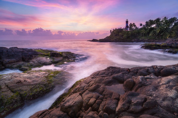 Colorful sunset at the Kovalam beach, Kerala, India. Lighthouse view. Long exposure.