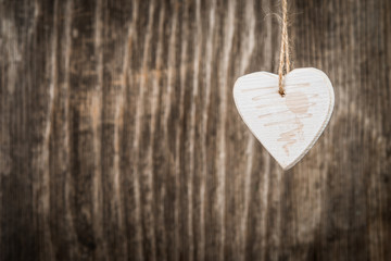 Christmas decoration in heart shape over rustic wood