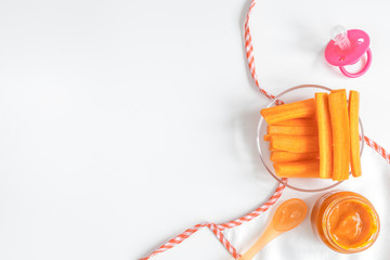 cooking mashed carrots for baby on white background top view