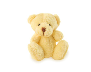 Classic teddy bear sitting on white background.