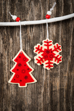 Red Christmas decorations over rustic wood