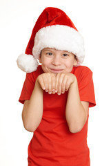 boy child portrait in santa hat, having fun and emotions, winter holiday concept