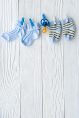 baby socks on rope at wooden background