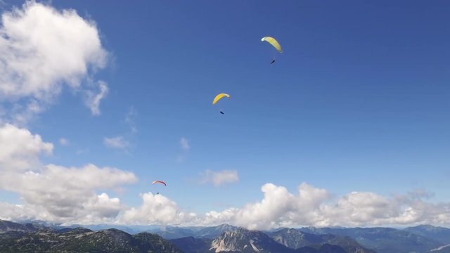 paragliding over the rocky Alps mountains landscape
