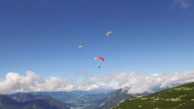 paragliding over the rocky Alps mountains landscape