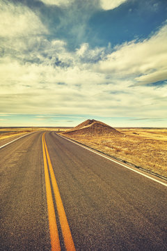 Vintage toned desert road, travel concept, USA.