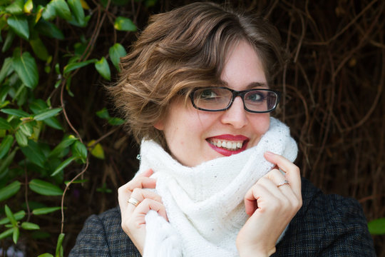 Young Woman Wearing White Scarf And Black Coat