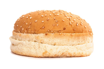 Burger bun with sesame seeds on white background