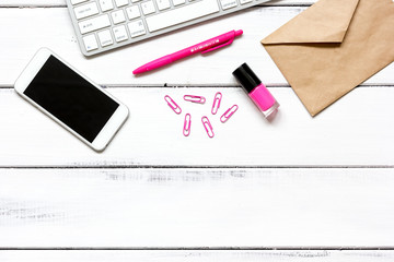 female wooden desktop with smartphone, paper envelopes top view
