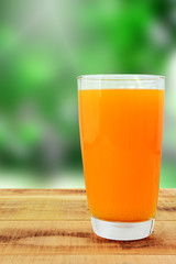 Fresh orange juice on wooden table.