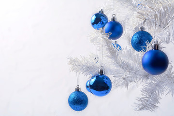 White Christmas tree with blue ornament copy space
