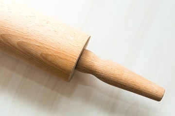 Close up of rolling pin lying on wooden table