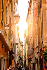 Printed roller blinds Beautiful view of scenic narrow alley street with historic traditional houses in an old town in Europe with blue sky and clouds in summer sunny day, with retro vintage Instagram warm filter effect