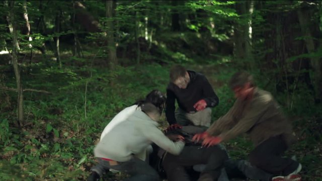 Zombie eat a man in the forest.