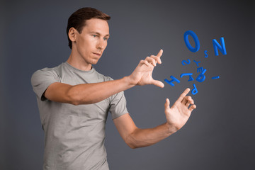 Man working with a set of letters, writing concept.