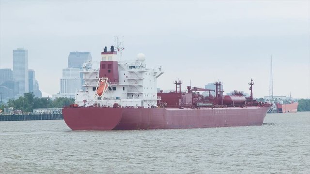 Generic Chemical Container Cargo Ship in the Mississippi River with New Orleans City Skyline in the Background