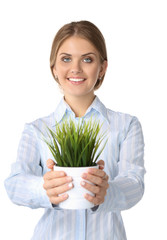 Businesswoman holding a plant smiling at the camera