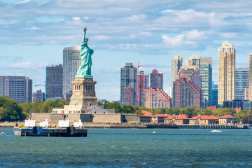 The Statue of Liberty in New York with skyscrapers on the background