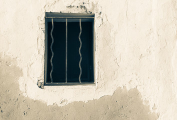 Fototapeta na wymiar Window opening with security bars in wall