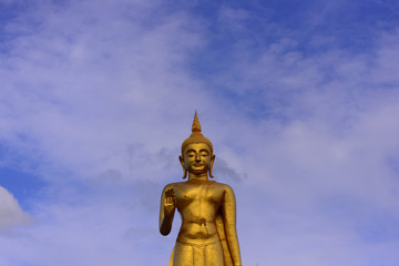 Fototapeta na wymiar Buddha statue on blue sky