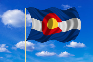 Flag of Colorado waving on blue sky background