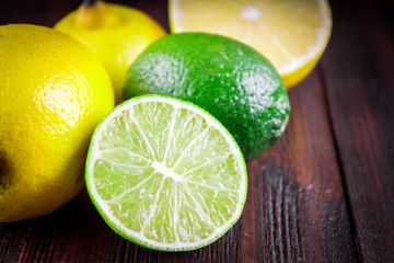 Fototapeta na wymiar lemons and limes on a wooden background