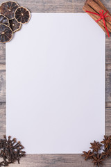 Spices like frame with white paper for text on wooden background