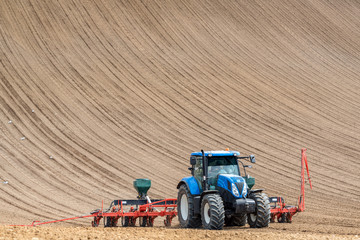 Tractor harrowing the field
