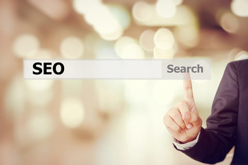 Businessman hand touch screen SEO, search engine optimization