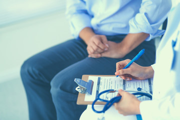Doctor woman sitting with male patient at the desk