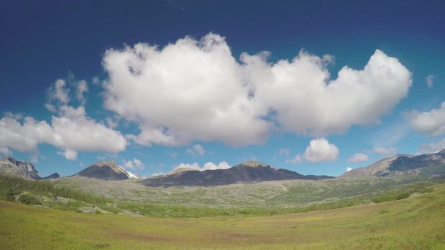 Alaska and Canada Border Scenic Mountain Scenery with Blue Sky and White Clouds Seen from Moving White Pass and Yukon Route Railroad Train