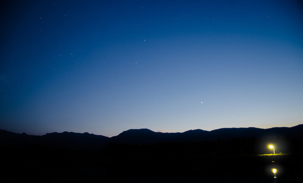 A landscape of night sky and silhouette mountain view