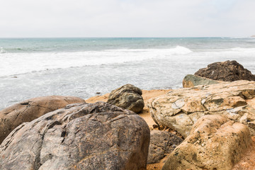 Boulders with an ocean background on a cloudy day at the Point Loma tide pools in San Diego, California.