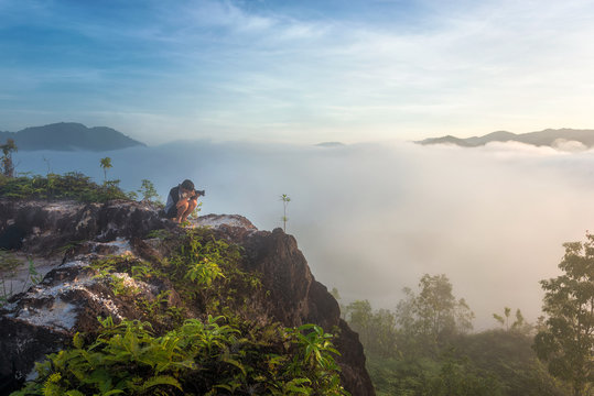Photography take a photo on the mountain and have a fog around the mountain. Thailand landscape