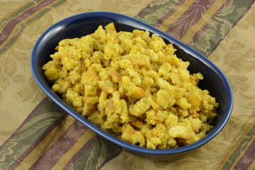 Cooked Turkey stuffing in blue bowl on tablecloth