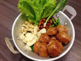 Isaan sausage, Thai Northeastern sausage, Thai pork mix rice sausage served in dish on wooden table background