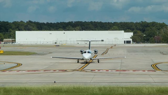Generic Executive Business Jet on Taxi and Runways at Modern Airport on Sunny Day with Hot Sunshine Weather
