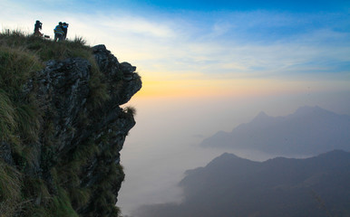 Soft focus beautiful sunrise and fog in the mountains at Phu Chi Fa of Chiang Rai, Thailand.