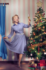 portrait of nice young woman hanging around christmas tree on x-mas  eve  