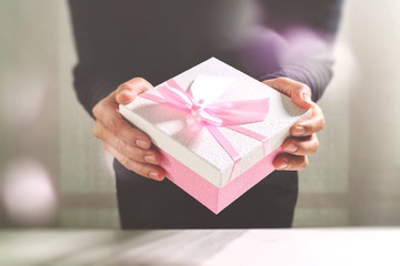 gift giving,man hand holding a gift box in a gesture of giving.b