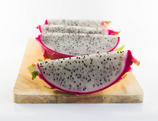 Dragon fruit on wooden chopping board