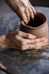 pottery making. hand transforming clay close up